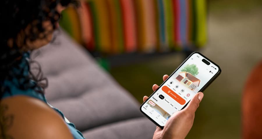 Customer checking the HomeView upgrade in the Vivint app to look at automation, security, and energy usage.